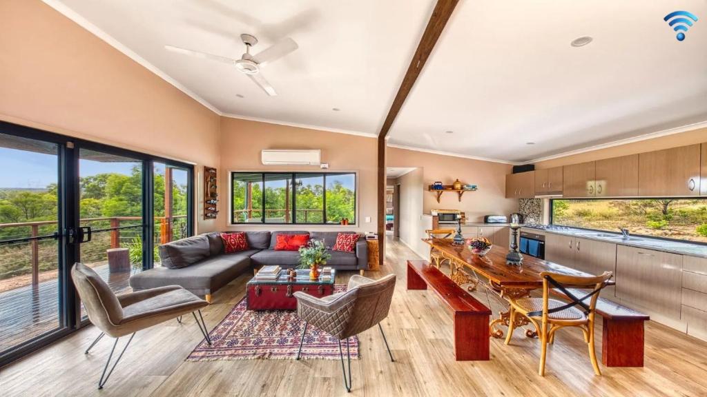 a living room with a couch and a table at Tea Tree Hollow in Canyon Leigh