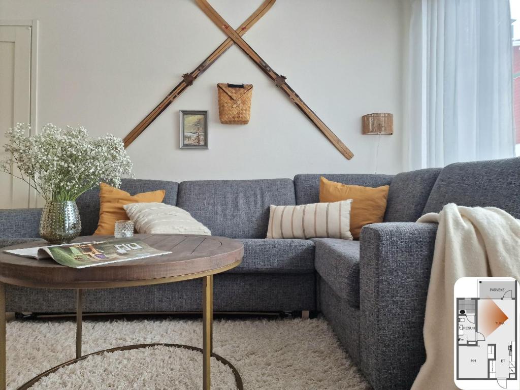 a living room with a blue couch and a table at Levistar II, apartment 310 in Levi