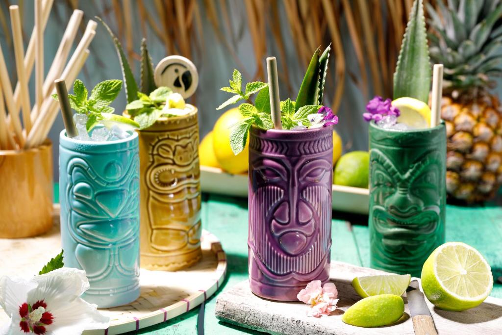 four vases with plants in them on a table at ROBINSON ESQUINZO PLAYA - All Inclusive in Morro del Jable