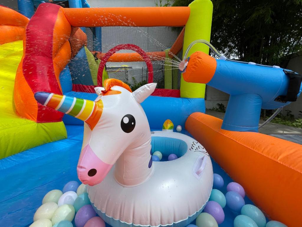 a inflatable toy horse in a pool of balls at Batuferringhi children waterslid paradise 3mins to the beach in Batu Ferringhi