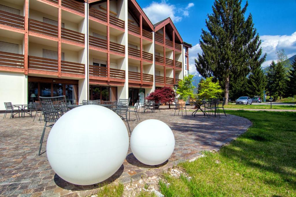 Deux grandes balles blanches devant un bâtiment dans l'établissement Al Ponte Garnì, à Pergine Valsugana