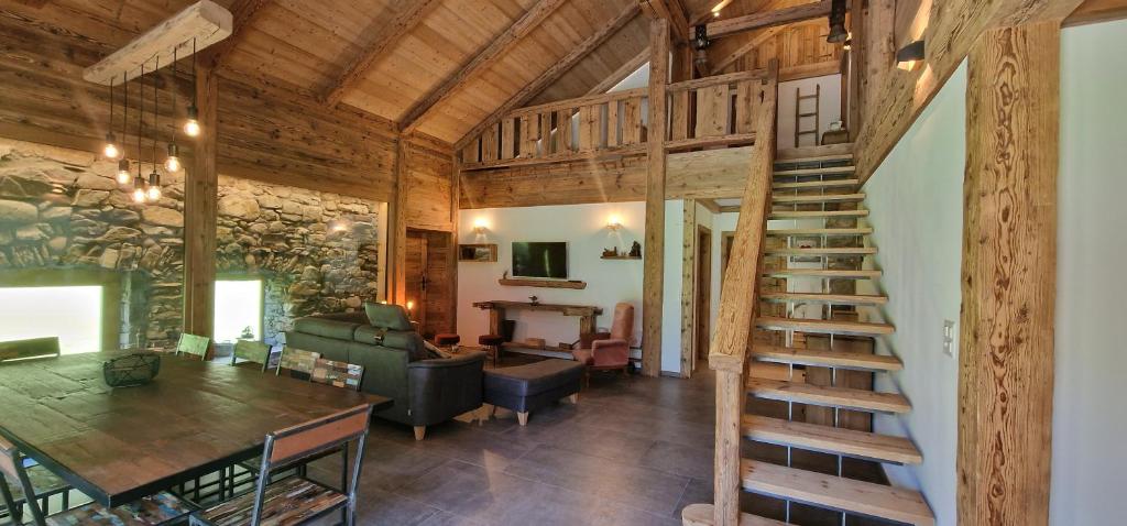 a living room with a spiral staircase in a cabin at Ferme à Marius in Champéry