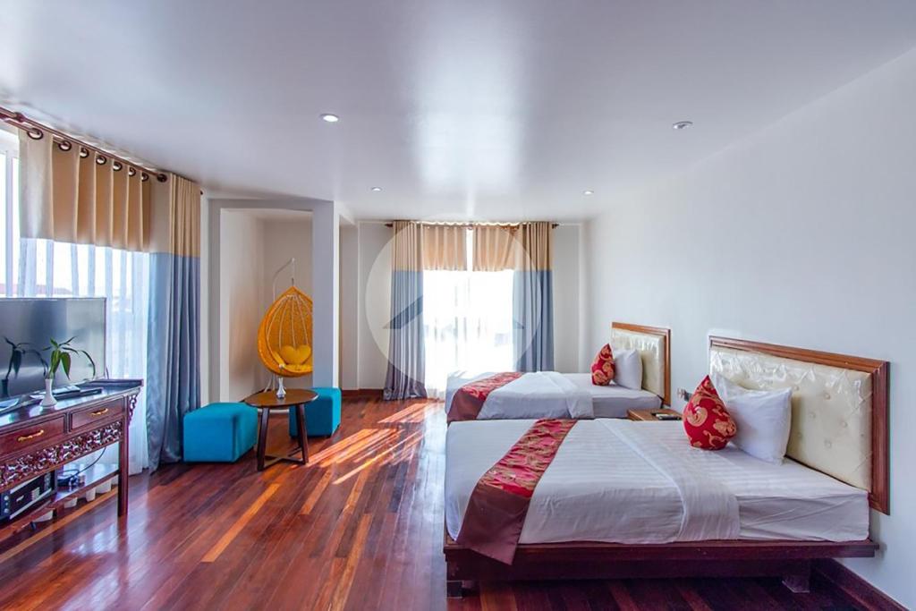 Postel nebo postele na pokoji v ubytování Zita Angkor Hotel