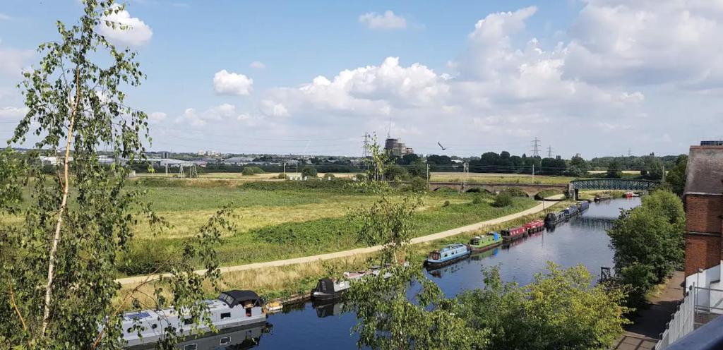 a river with boats on it and a bridge at Idyllic flat over River Lea in London