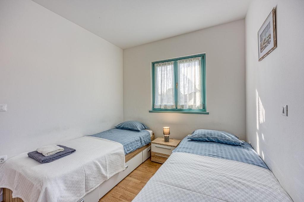 Łóżko lub łóżka w pokoju w obiekcie Apartment Anita