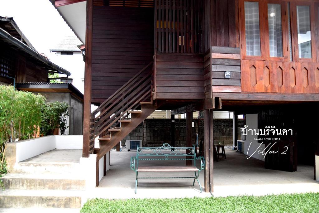a tree house with a staircase and a bench at V2-Baan Borijinda-Lanna House in The old city of Chiang Mai in Chiang Mai