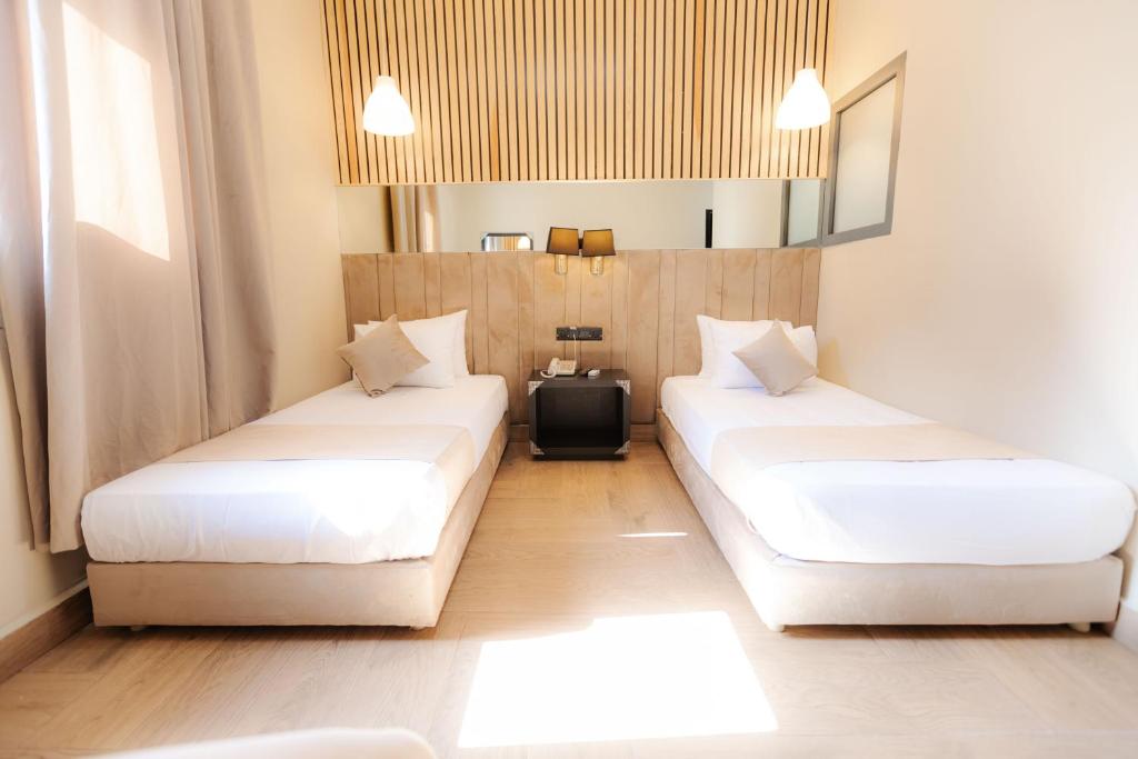 Postel nebo postele na pokoji v ubytování Ennesma Hotel