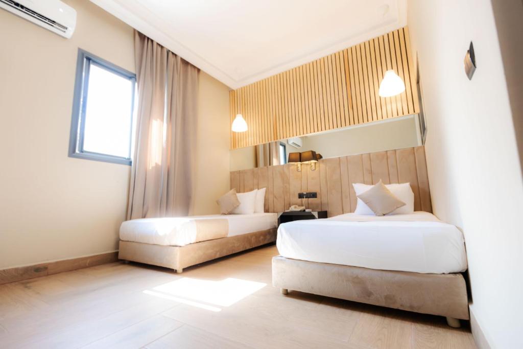 Postel nebo postele na pokoji v ubytování Ennesma Hotel
