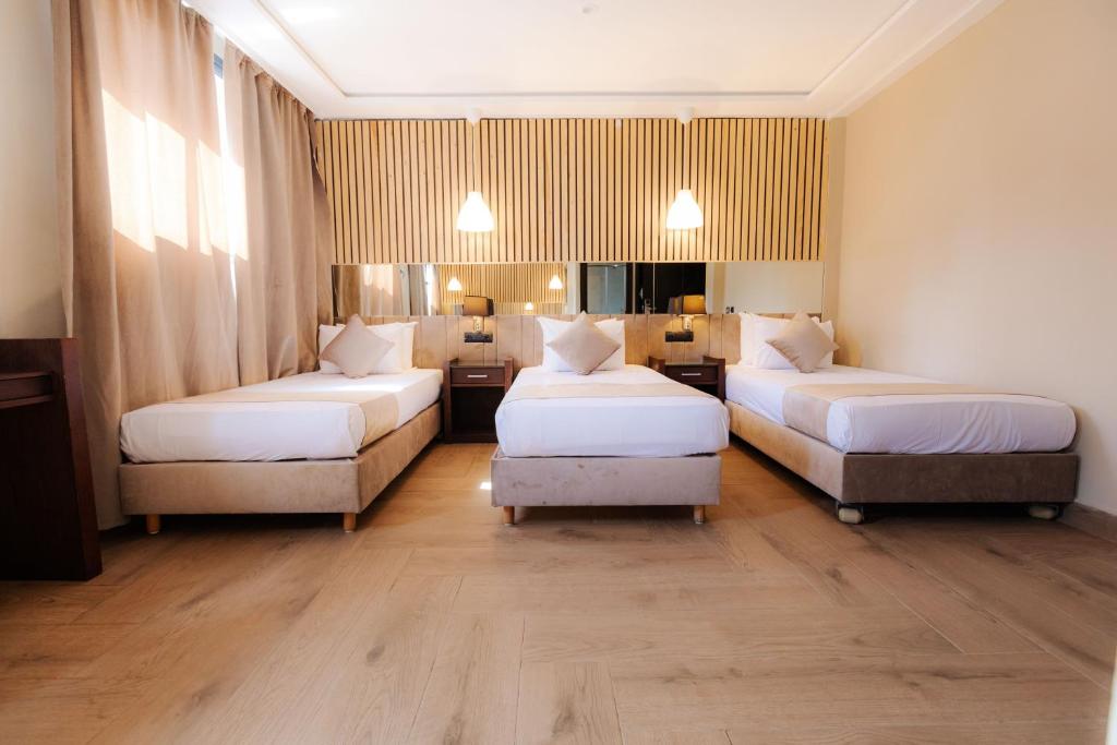 Postel nebo postele na pokoji v ubytování Ennesma Hotel