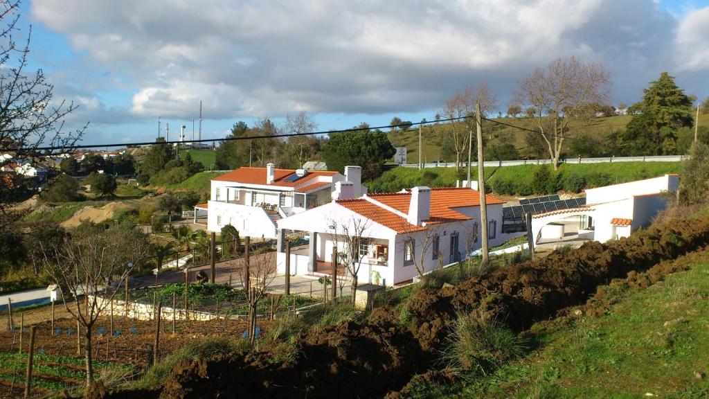 a white house with a red roof on a hill at Holiday home Monte das Azinheiras in Arraiolos