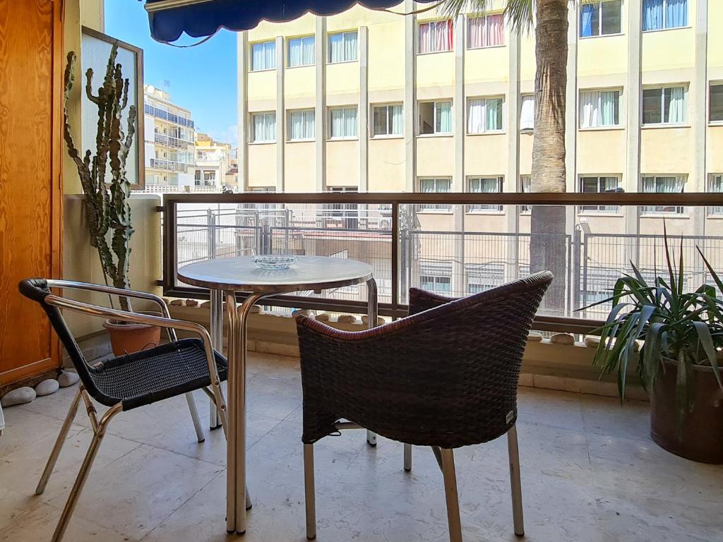 a balcony with a table and chairs and a window at Apartamento Balcón de la Luna in Benidorm