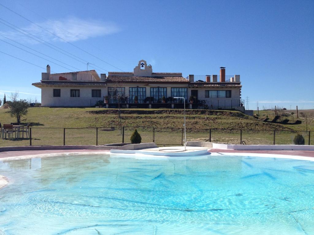 a large swimming pool in front of a house at La Simona in Los Cerralbos