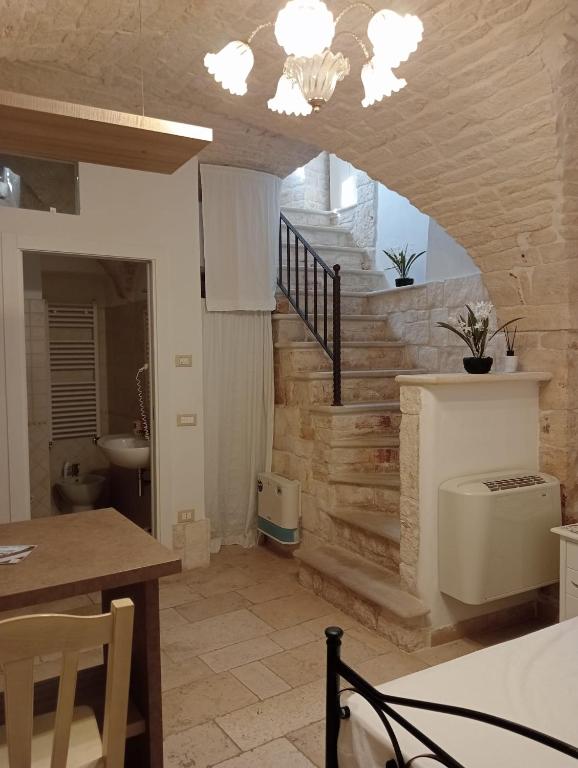 a kitchen with a staircase with a toilet in a room at trullo Le murge in Alberobello