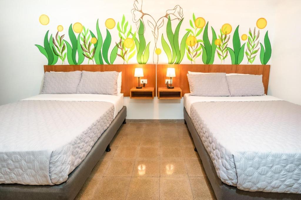 Postel nebo postele na pokoji v ubytování Hotel Caracas