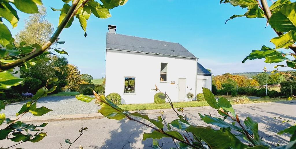 a white house on the side of a road at Les marmottes - Maison de vacances La Roche-en-Ardenne in La Roche-en-Ardenne
