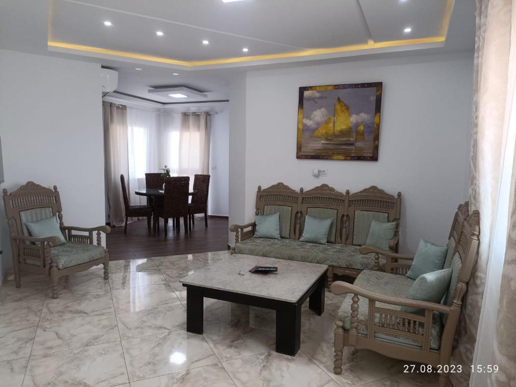 a living room with a couch and chairs and a table at TIM Haute standing appartment S2, center Monastir in Monastir