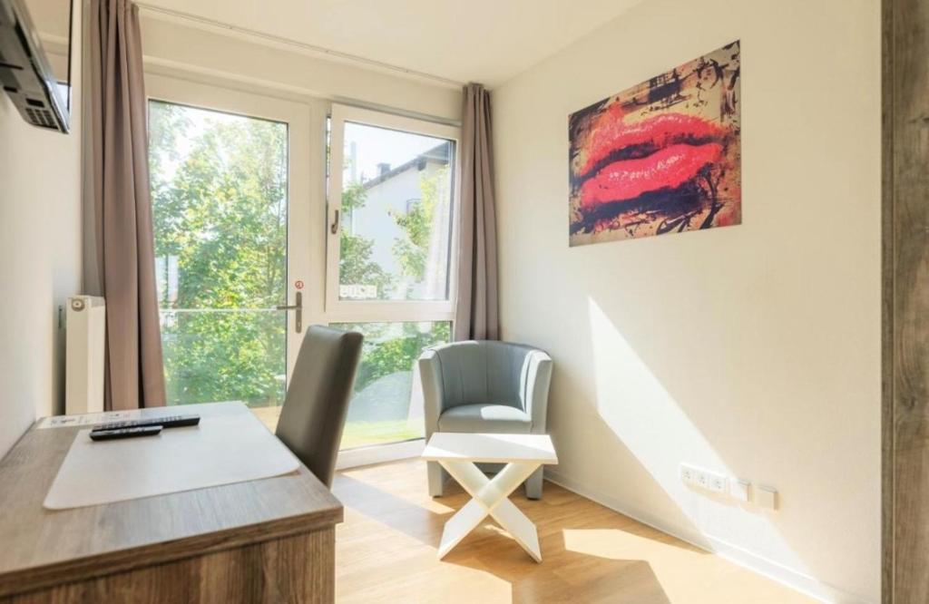 a home office with a desk and a chair at B - HOME Apartments in Koblenz