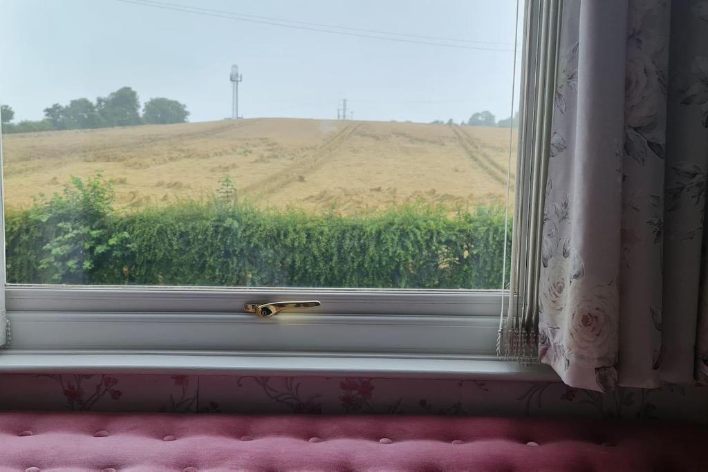 une fenêtre avec vue sur un champ dans l'établissement Immaculate 3-Bed House in Durham near Sedgefield, à Trimdon Grange