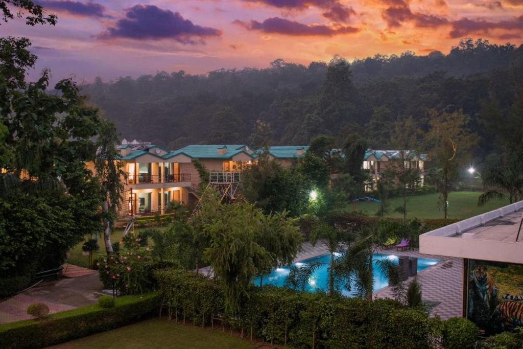 a view of a resort with a swimming pool at Winsome Resort & Spa Corbett in Rāmnagar