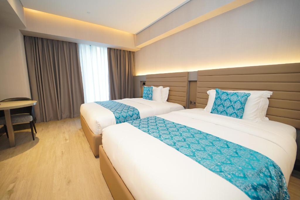 Postel nebo postele na pokoji v ubytování Bayprime Hotel