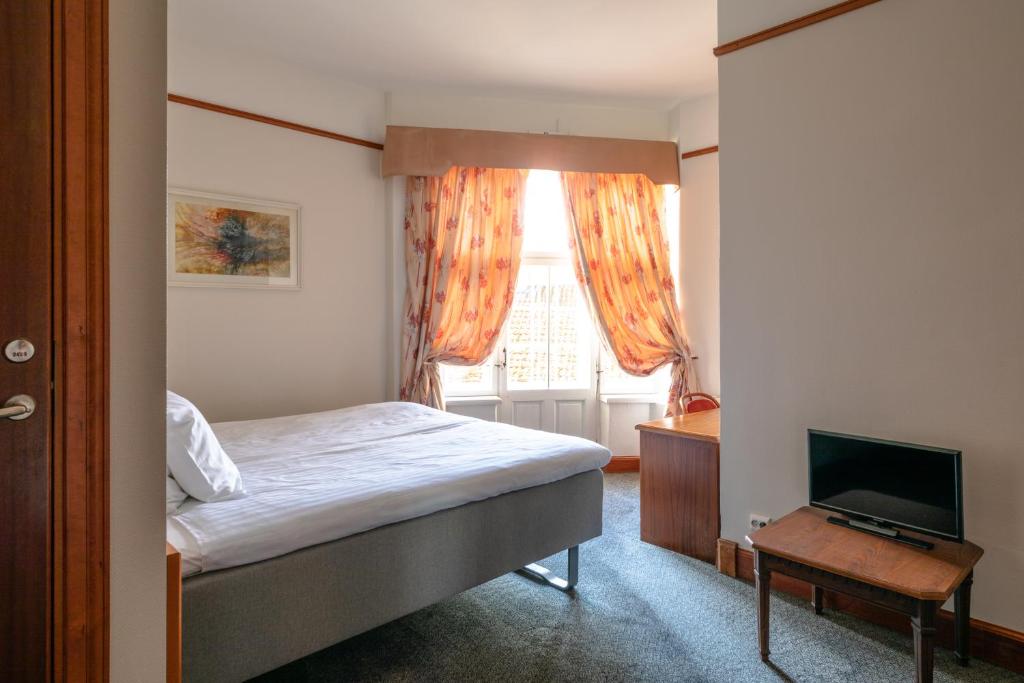 Postel nebo postele na pokoji v ubytování Hotel Victoria