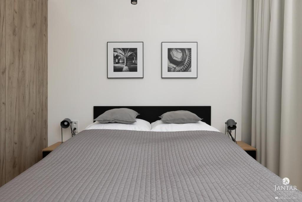 Posteľ alebo postele v izbe v ubytovaní Shellter Apartments 117 Ł - by Jantar Apartamenty
