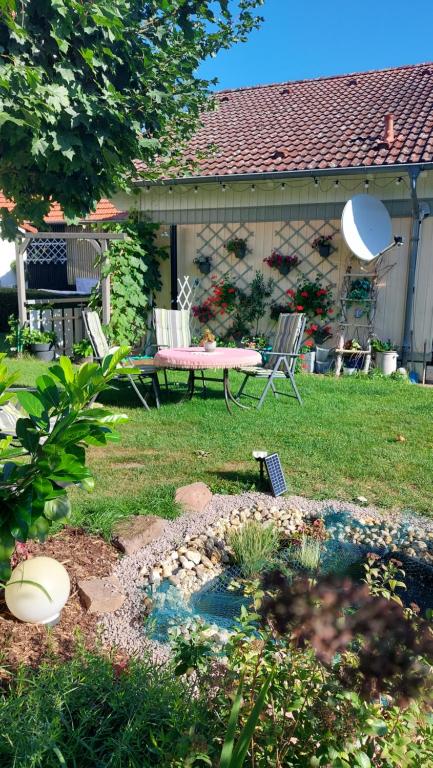 einen Garten mit einem Tisch und einer Bank im Hof in der Unterkunft Bergfeldhof in Haingrund