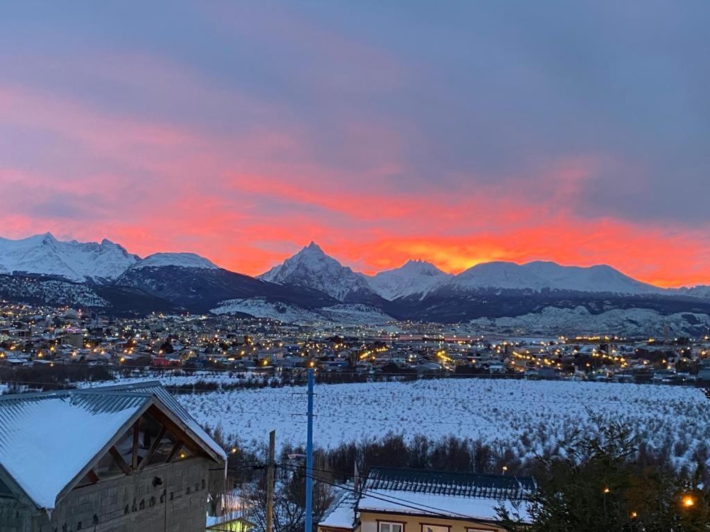 a view of a city at sunset with mountains at GAVIMAR in Ushuaia