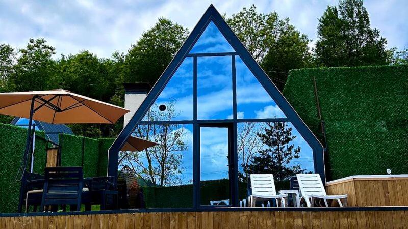 a group of chairs and umbrellas with a mirror at Mira Deluxe Bungalov in Sapanca