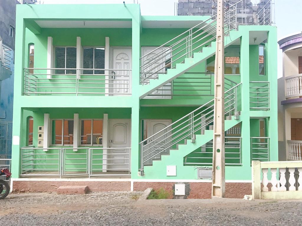 a green building with stairs on the side of it at Fogo Morabeza Tur in São Filipe