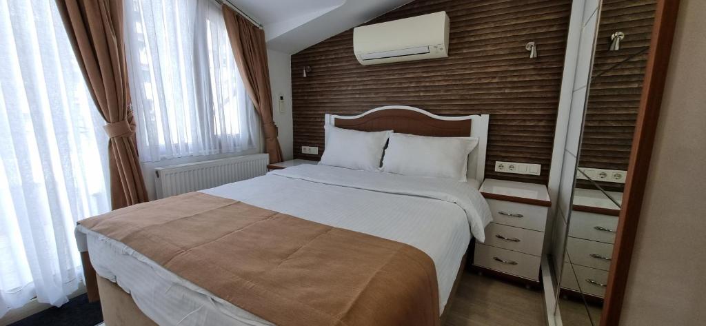 a bedroom with a large bed and a wooden wall at Taksim Flat in Istanbul