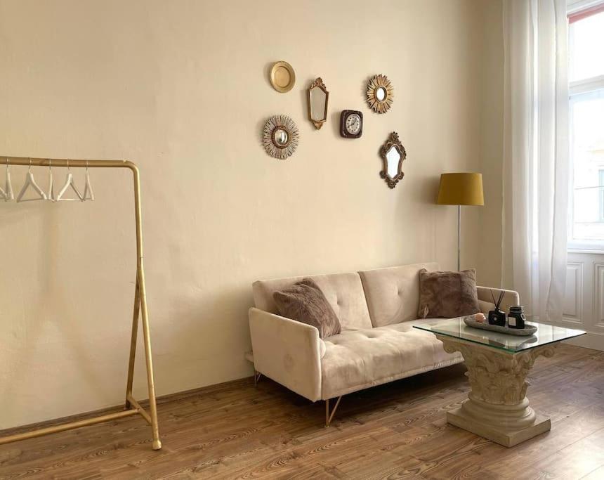 a living room with a couch and a table at Unique Apartments in Döbling in Vienna