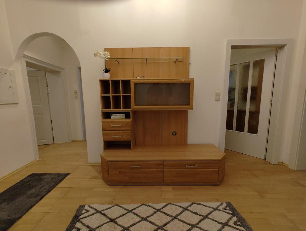 a living room with a tv and a wooden entertainment center at Altstadtparee in Steyr