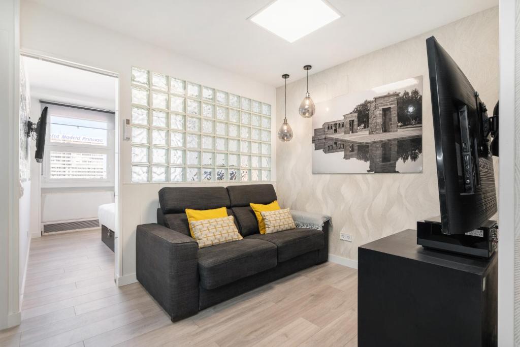 a living room with a couch and a flat screen tv at Plaza España Apartment in Madrid