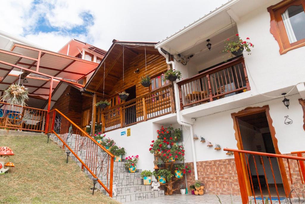 a house with a christmas tree on the balcony at Hospedaje Vista Hermosa Salento in Salento