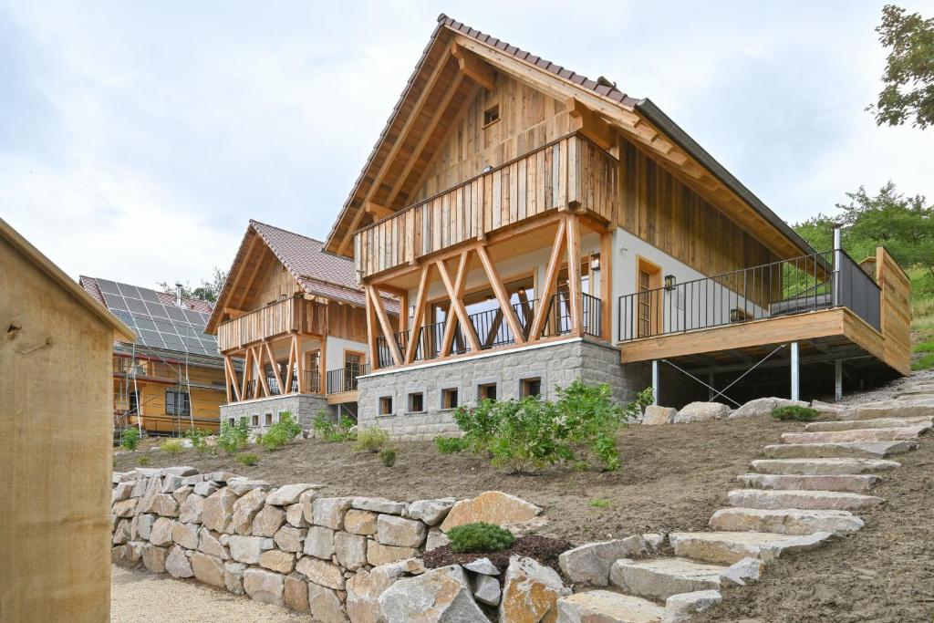 a log home with a stone retaining wall at Oma Ludwin in Sasbachwalden