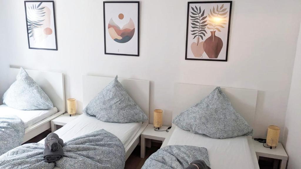 two beds in a room with pillows on them at Nice Apartment in Apolda in Apolda