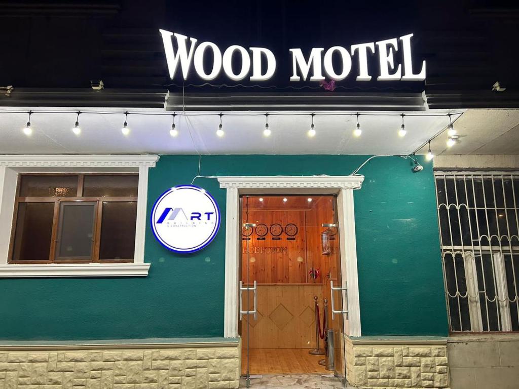 a wood motel sign on the front of a building at WOOD MOTEL in Mingachevir