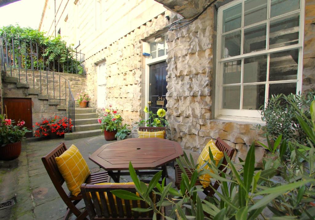 a patio with a table and chairs in front of a building at City Centre New Town 2 Bedroom Flat in Edinburgh