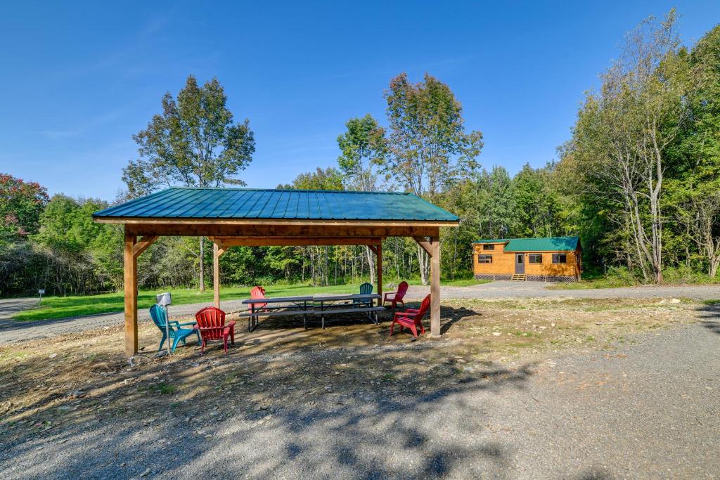 a gazebo with chairs and a picnic table at Catskills Tiny Home Cabin Surrounded by Nature! in Franklin