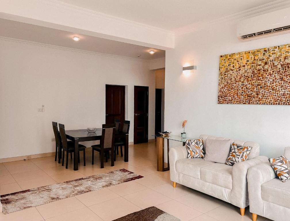 a living room with a couch and a table at Elles Residence in Dar es Salaam