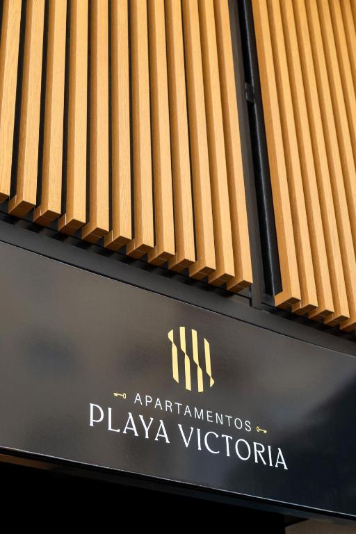 a sign for a playavictoria on a building at Apartamentos Playa Victoria in Cádiz
