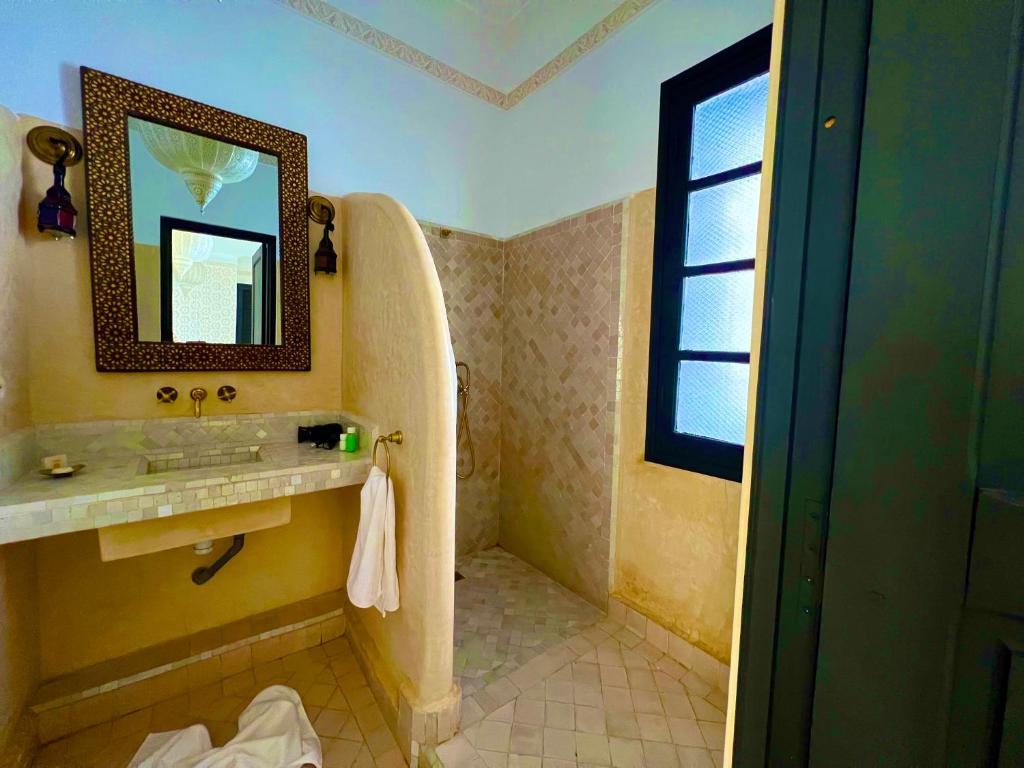 uma casa de banho com um lavatório e um espelho em Riad New Moon em Marrakech