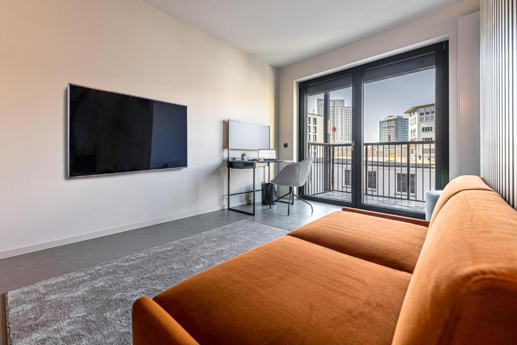 TV a/nebo společenská místnost v ubytování YUMA Apartments Leipzig Berliner Straße