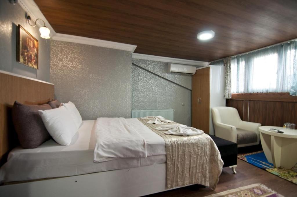 a bedroom with a bed and a bathroom with a sink at The New Season Apart in Istanbul