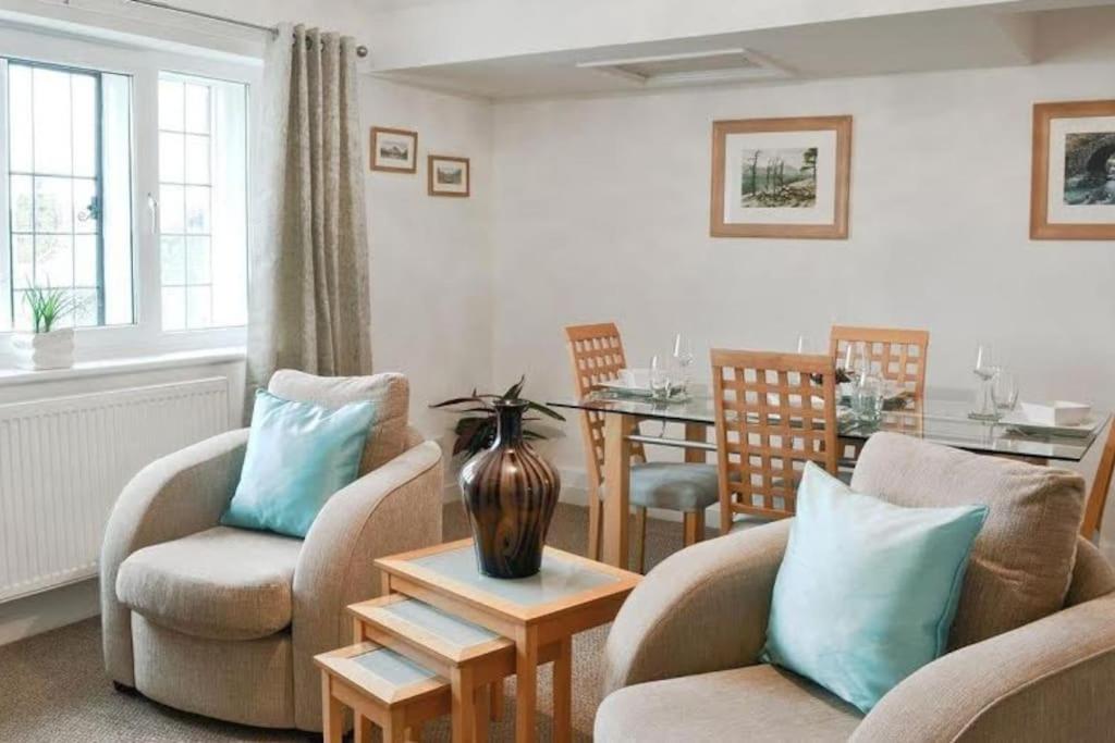 a living room with two chairs and a table at The Rafters, Bank House, Stunning Apartment. in Millom