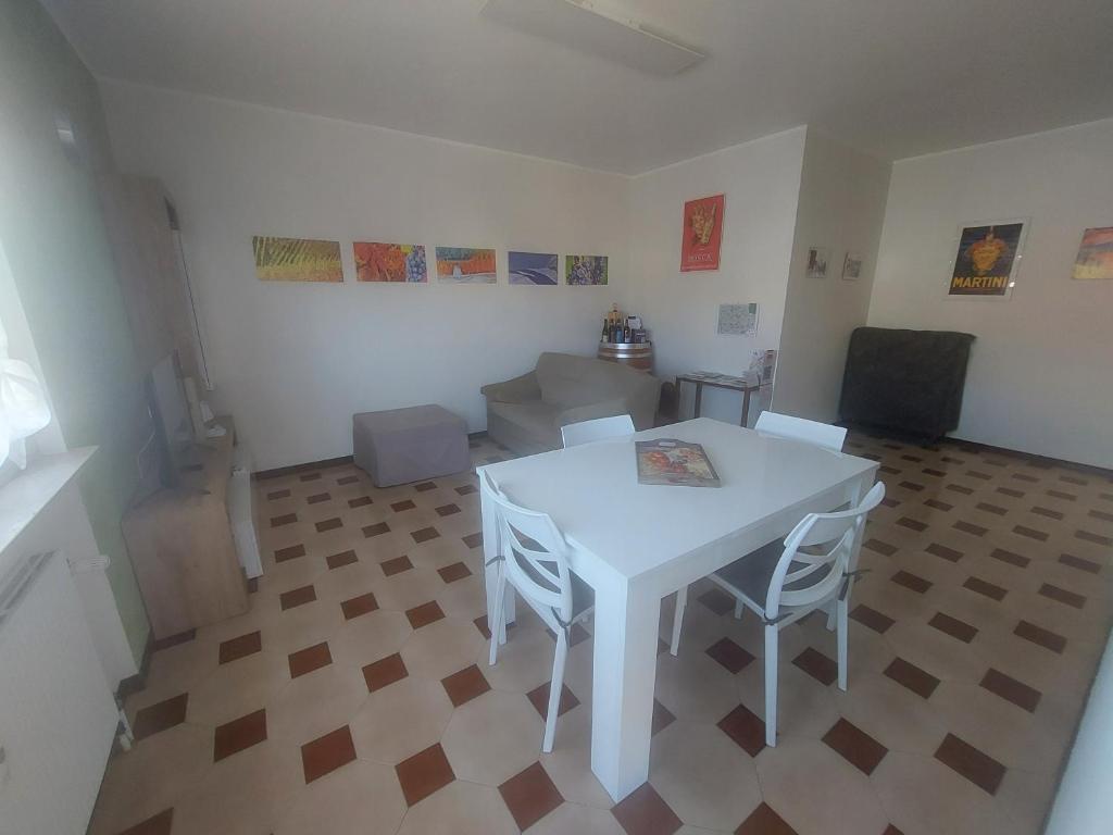 a white table and chairs in a living room at AGLIANO LOVELY APARTMENT in Agliano Terme