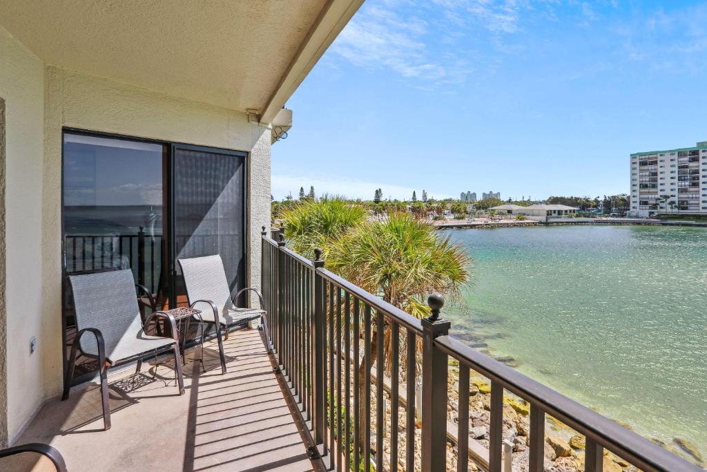 a balcony with chairs and a view of the water at Land's End 5-303 Gulf-Bay Front in St Pete Beach