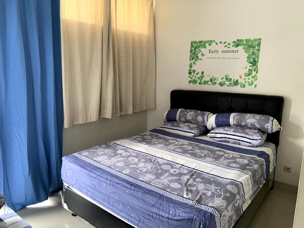 a bedroom with a bed with blue sheets and pillows at Awana Dream 4 bedrooms house , 5min to Alun Alun, Kraton, Malioboro bdc in Yogyakarta