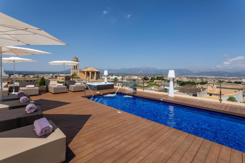 a pool on the roof of a building at Can Ribera by Zafiro in Muro